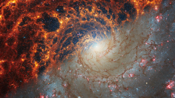 Face-on spiral galaxy, NGC 628, is split diagonally in this image: The James Webb Space Telescope’s observations appear at top left, and the Hubble Space Telescope’s on bottom right. 
